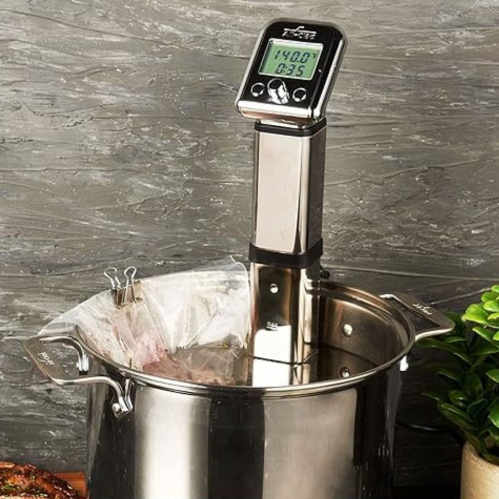 An All-Clad Sous Vide Immersion Circulator is submerged in a water-filled steel cooking pan. (Photo courtesy of Amazon/All-Clad Sous Vide Review)