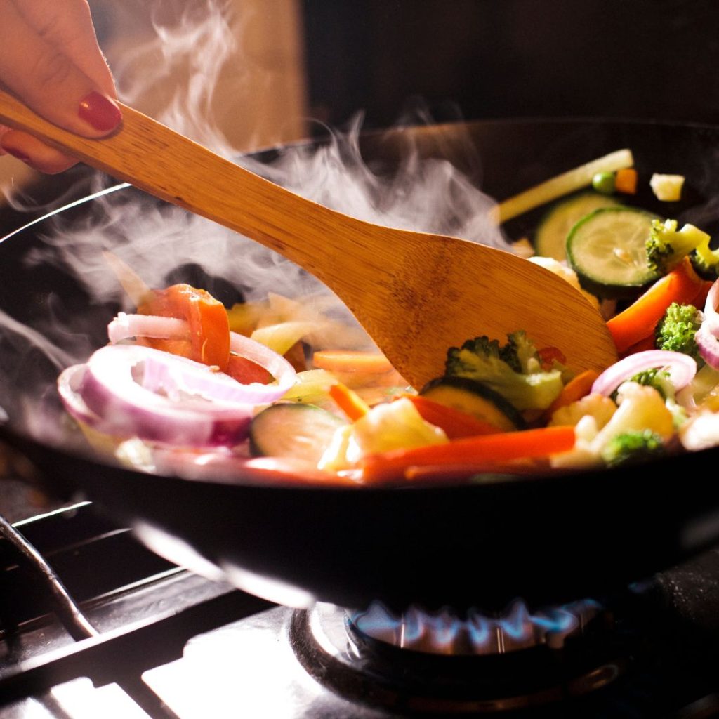 A variety of vegetables are stir-fried on high heat.