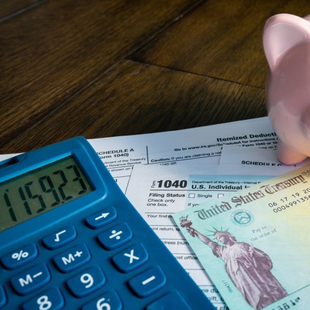 A calculator rests on a pile of paper.