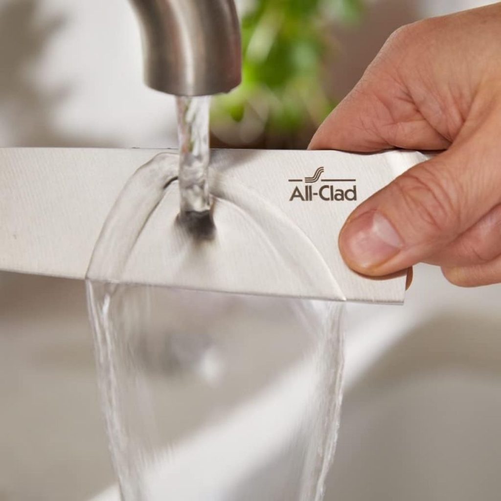 An All-Clad forged knife gets rinsed on running water. (Photo courtesy of Amazon)