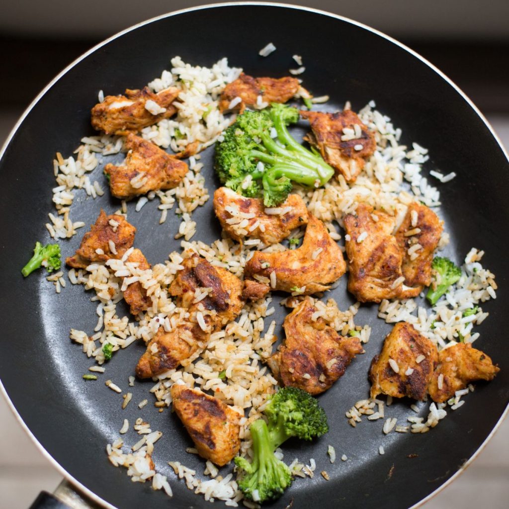 Meat and vegetables are cooked on a non-stick pan.