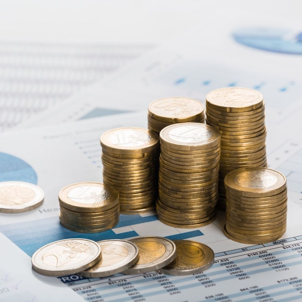 A stack of coins rests on a piece of paper.