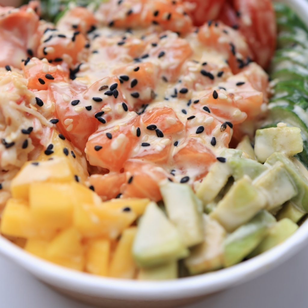 A bowl of salad sprinkled with black sesame seeds