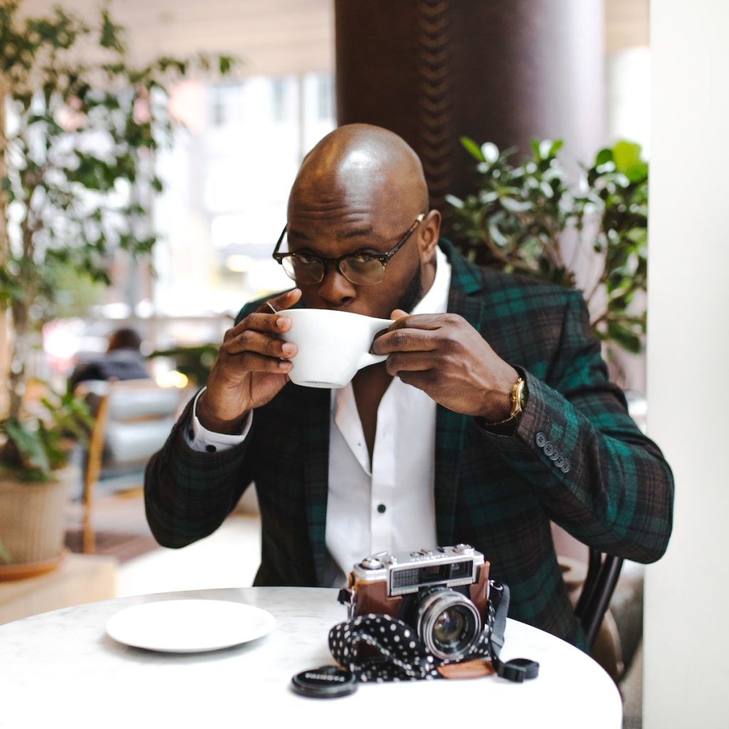 A man drinking black sesame latte