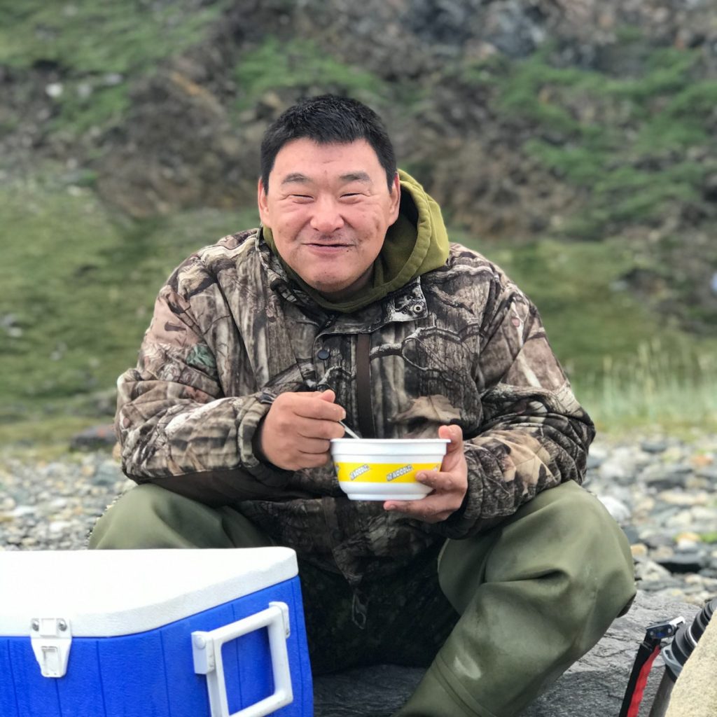 A person holding a bowl of black sesame soup