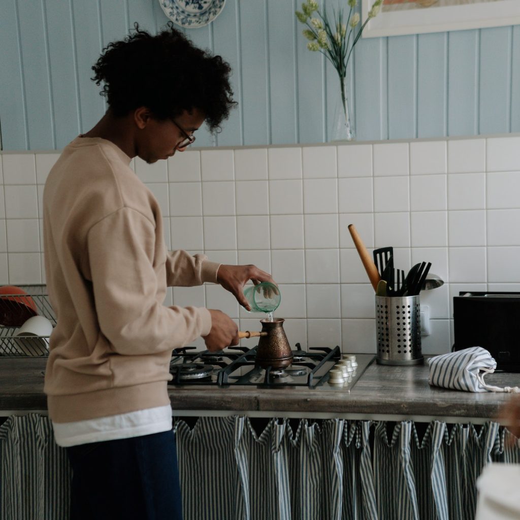 A person making a black sesame latte