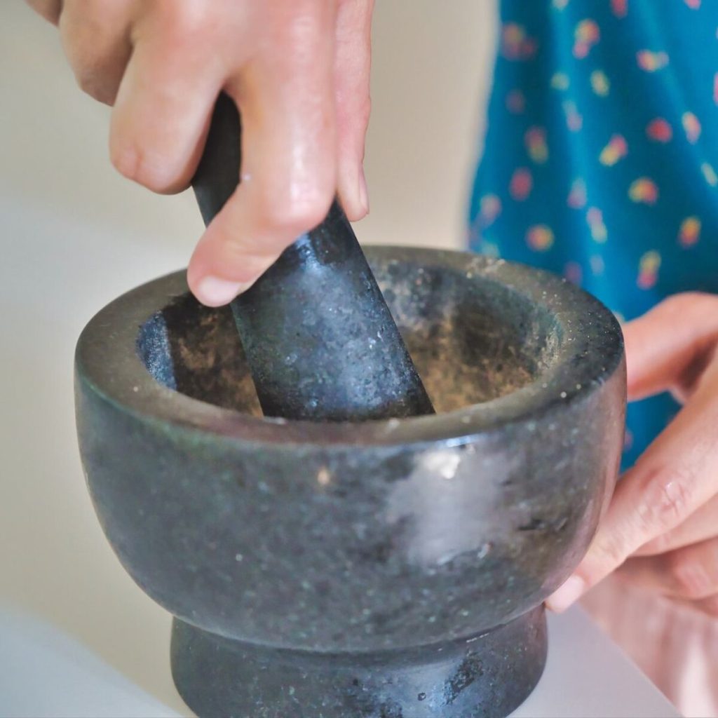 A person using a mortar and pestle