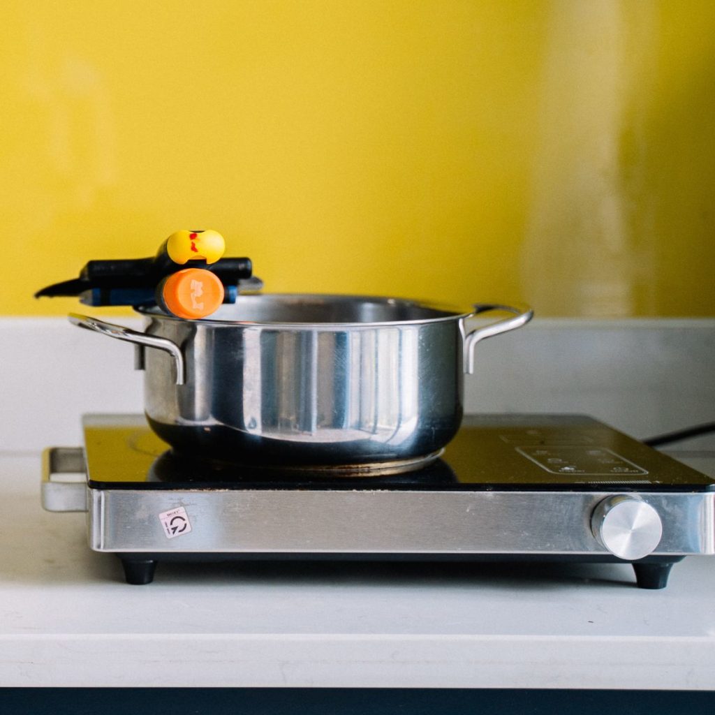 A stainless steel pan rests on top of an electric stove.