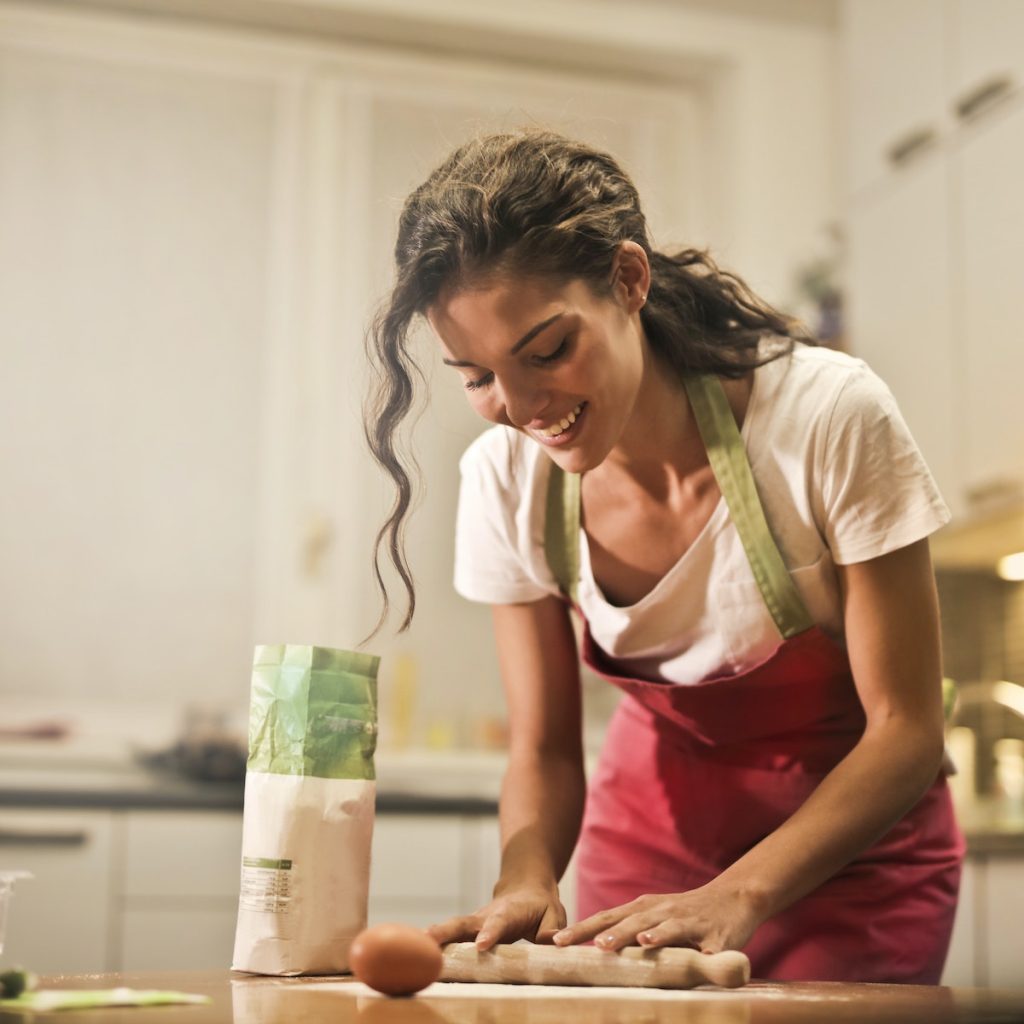 A woman using a rolling pin