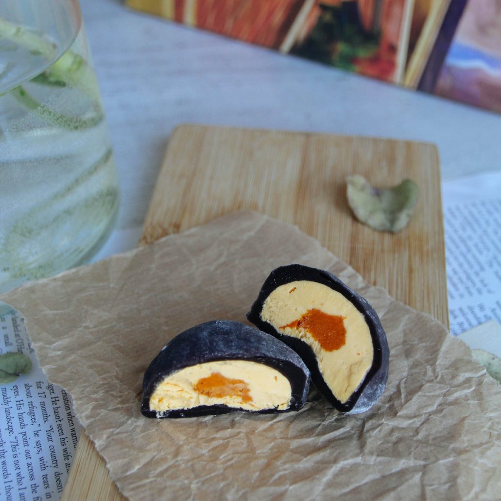 Black sesame mochi with yellow and orange filling