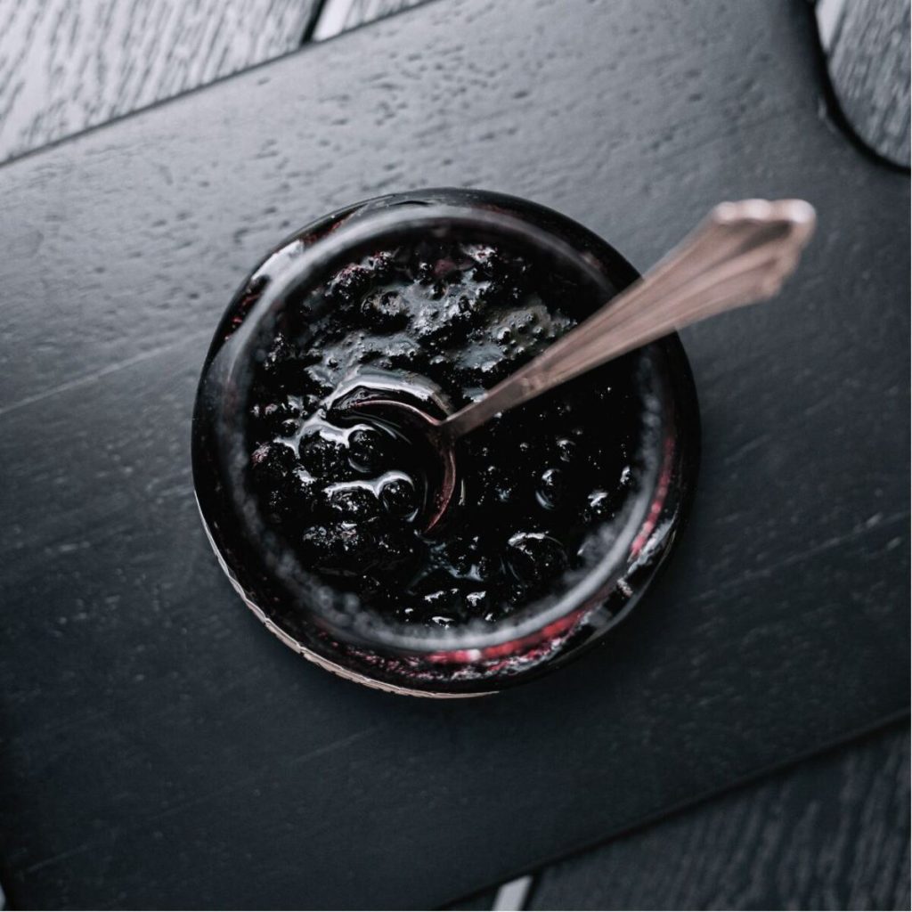 Black sesame paste in a jar with a spoon