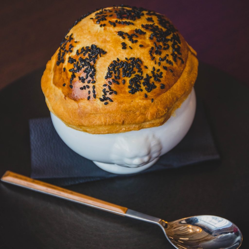 Pastry on a cup sprinkled with black sesame seeds