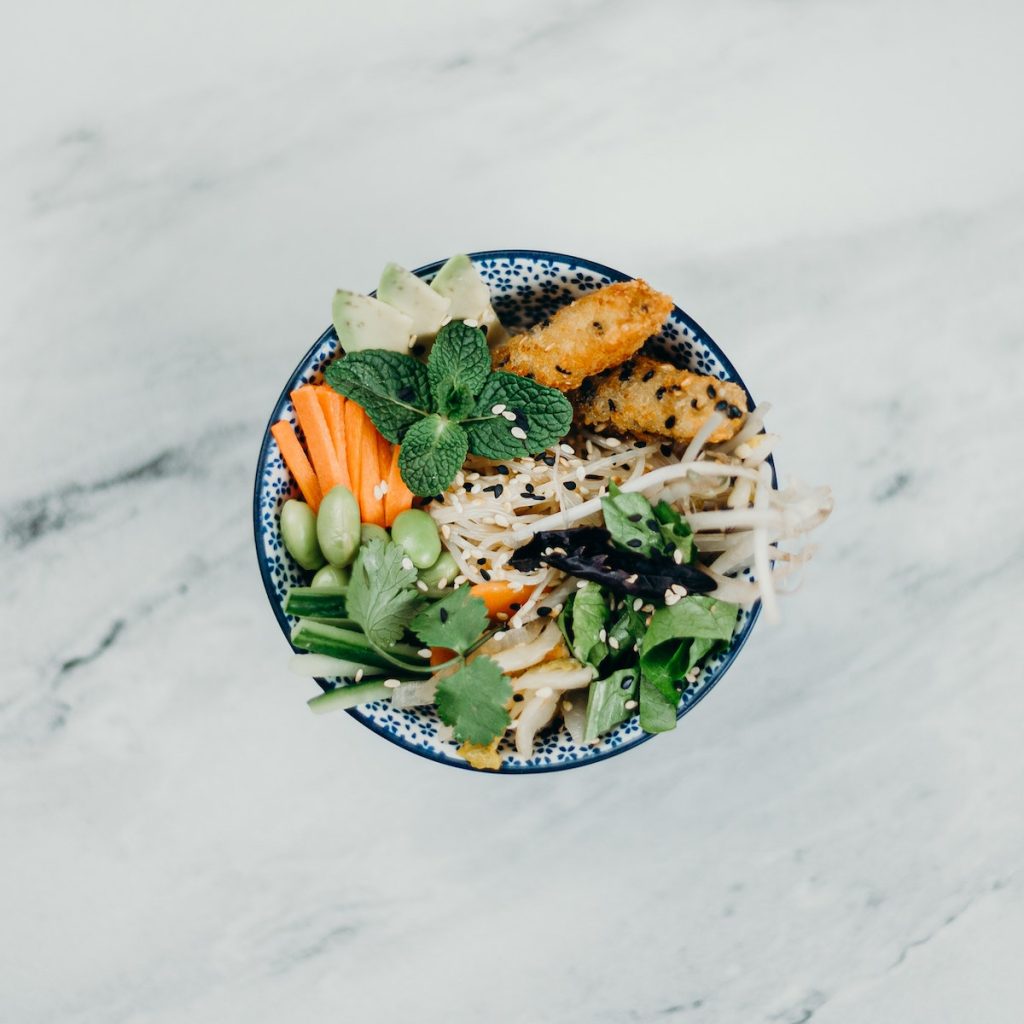 Healthy food in a bowl sprinkled with white and black sesame seeds