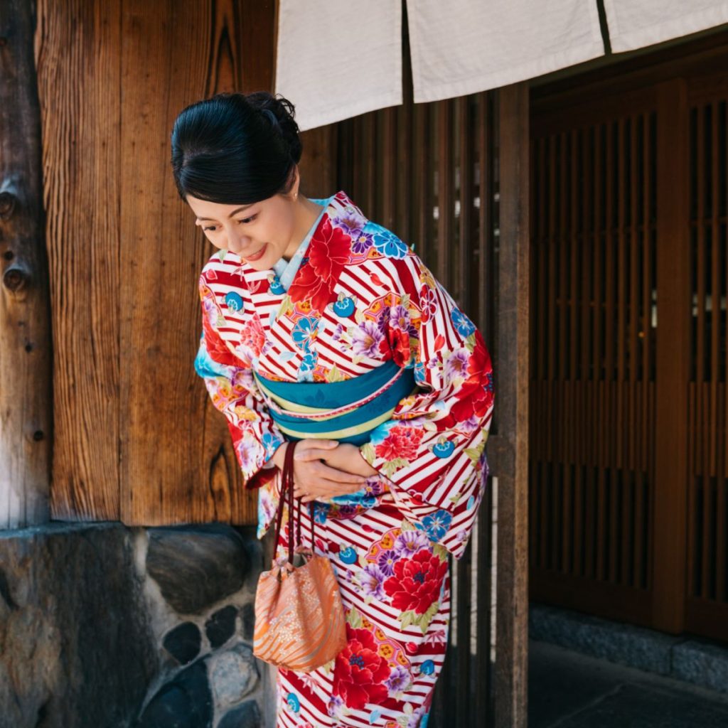 a woman bowing as sign of Japanese Etiquette