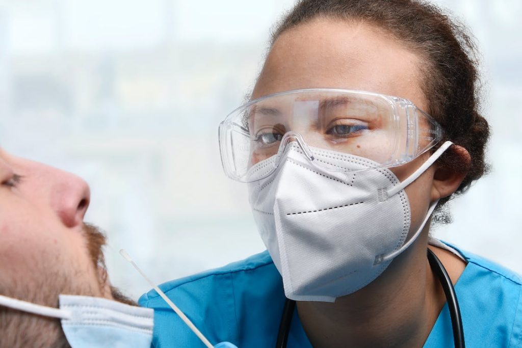 Nurse administering Covid 19 PCR Test