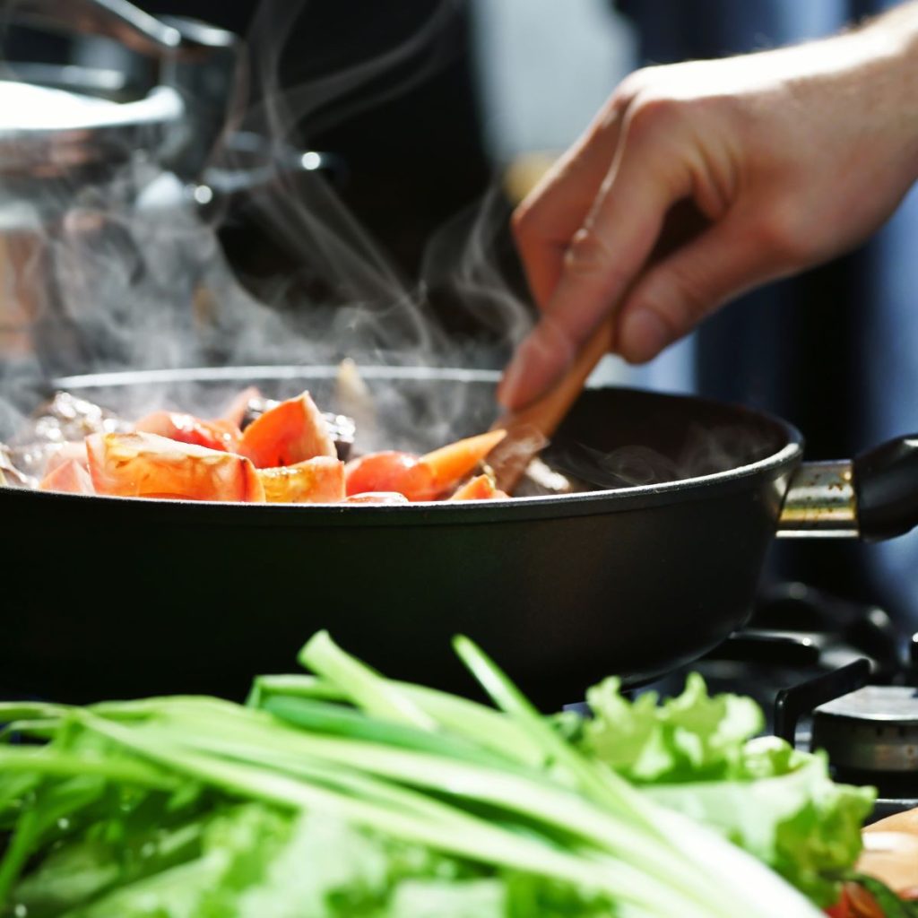 Person cooking with the use of a bamboo utensil