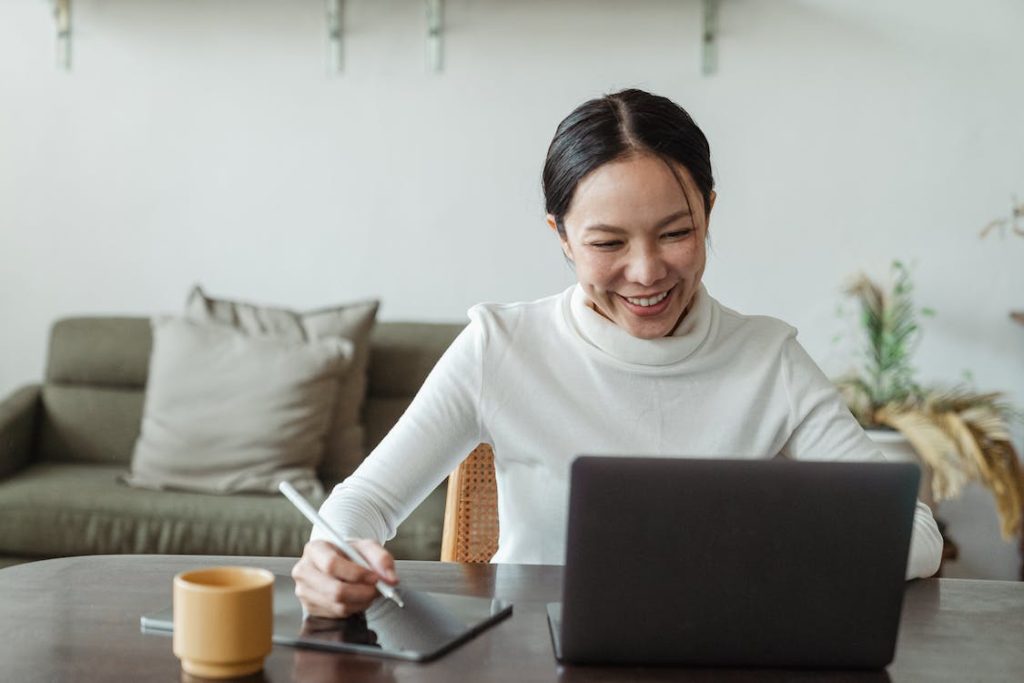 Smiling lady looking at a laptop