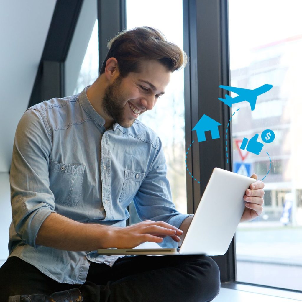 Smiling man looking at a laptop