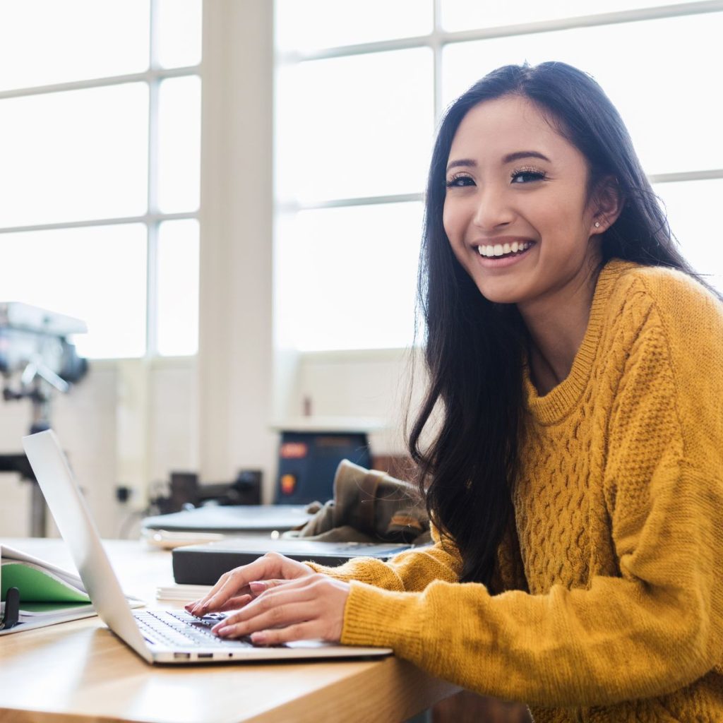 smiling lady using a laptop