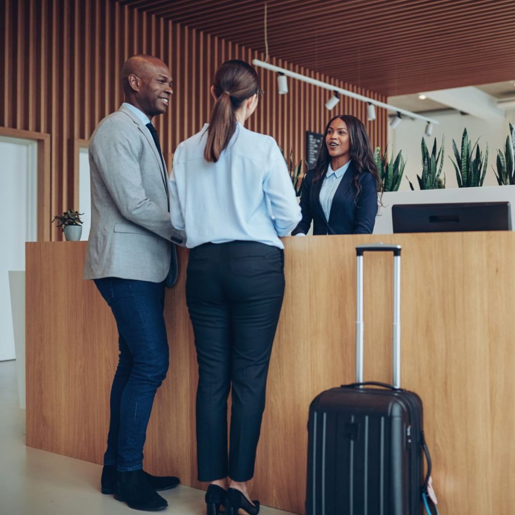 Two guests checking in at a hotel reception