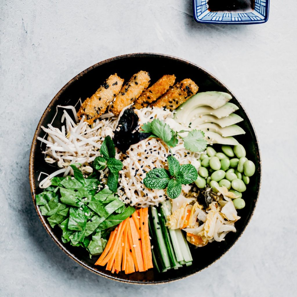 Vegetables in a bowl sprinkled with black sesame seeds