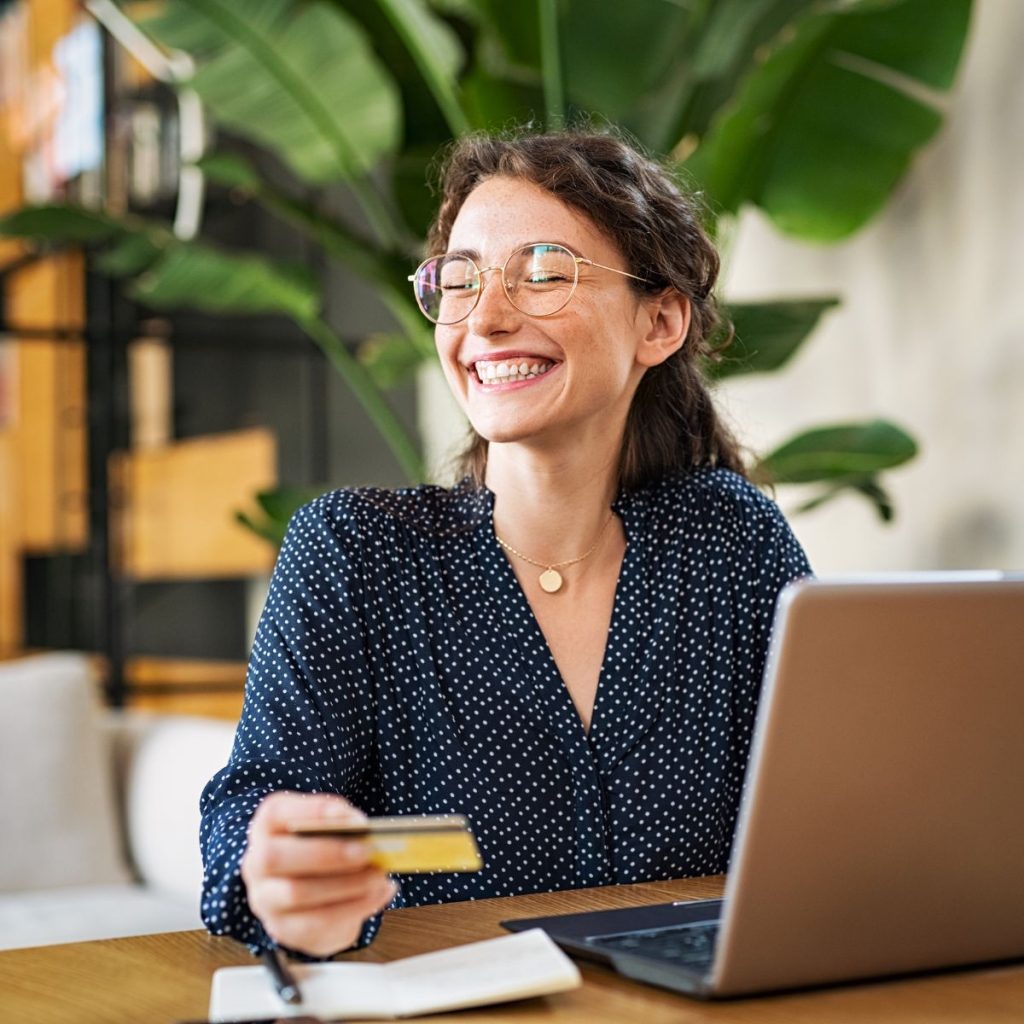 woman with her laptop using her credit card