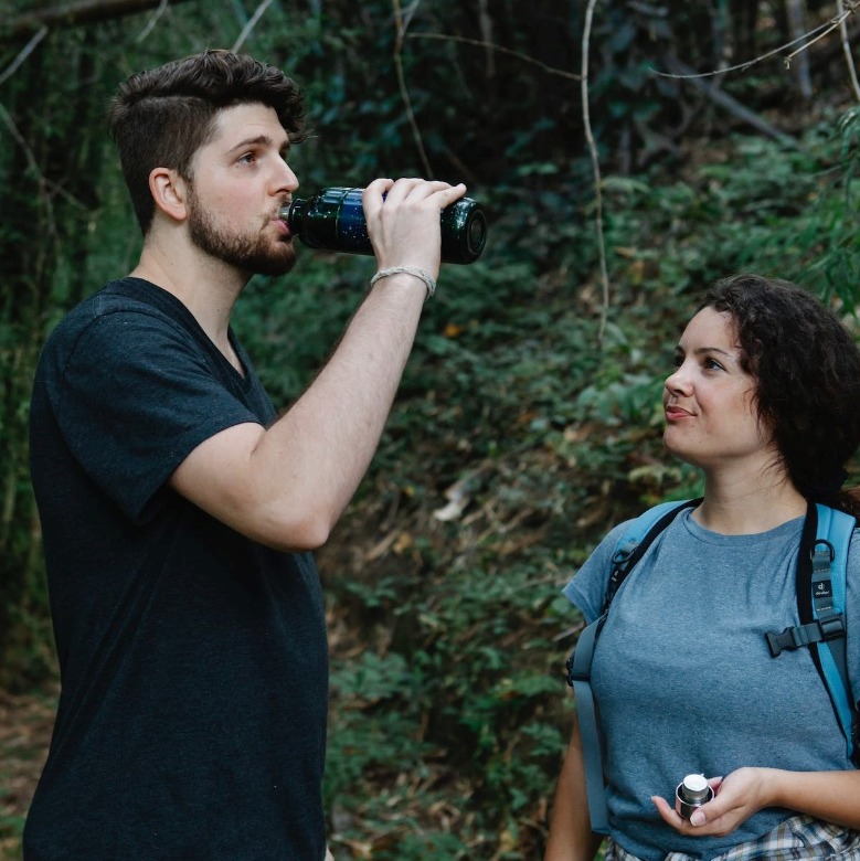 a man drinking from a water bottle