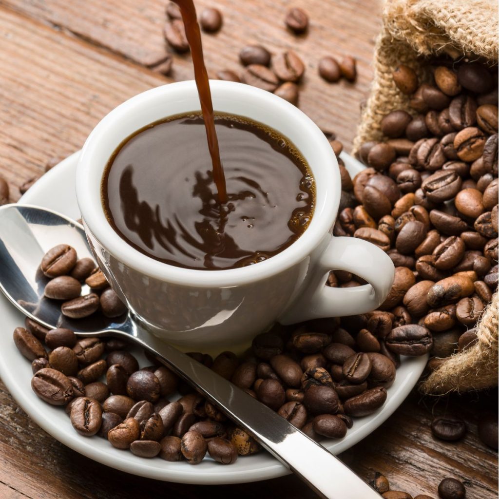 a mug of coffee with coffee beans