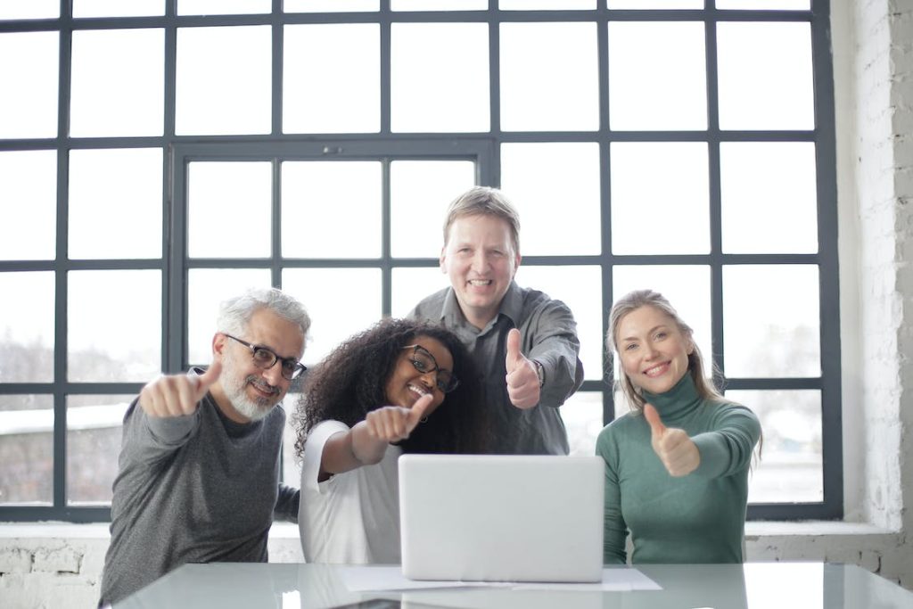 group of people giving a thumbs up