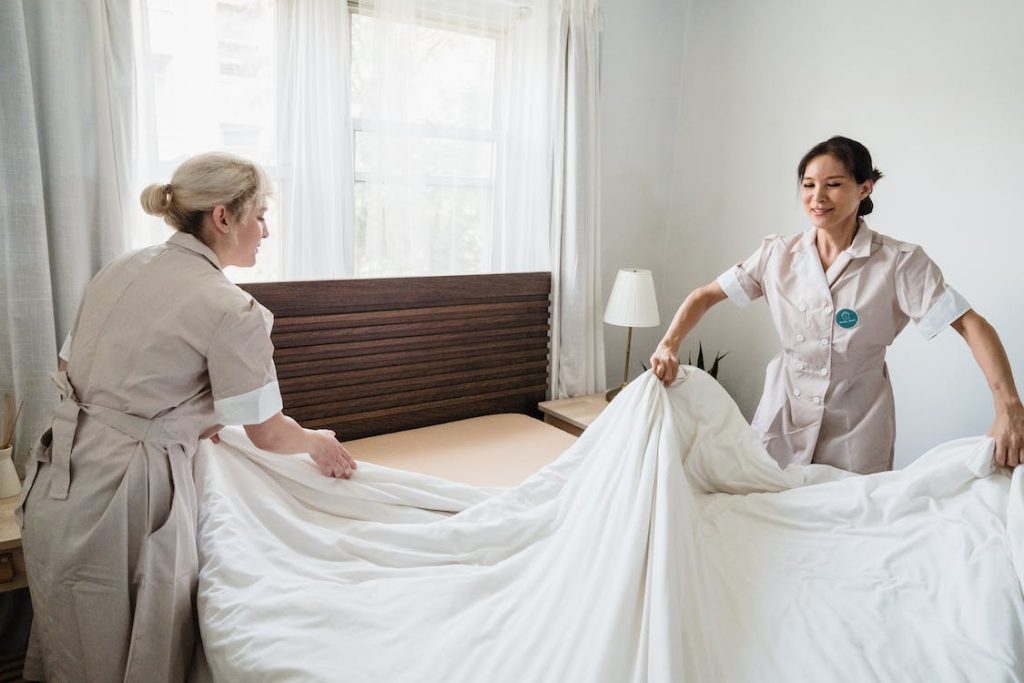 hotel staff changing the bedsheet