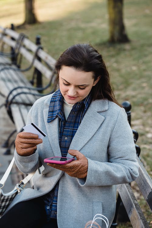 lady paying using her card and her mobile phone