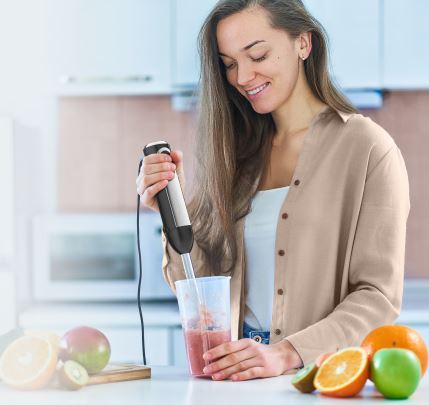 lady using a hand blender