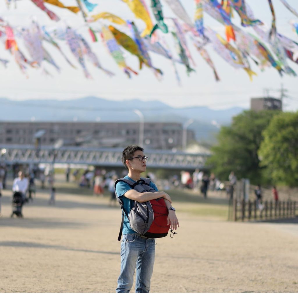 man standing in an open field during the golden week