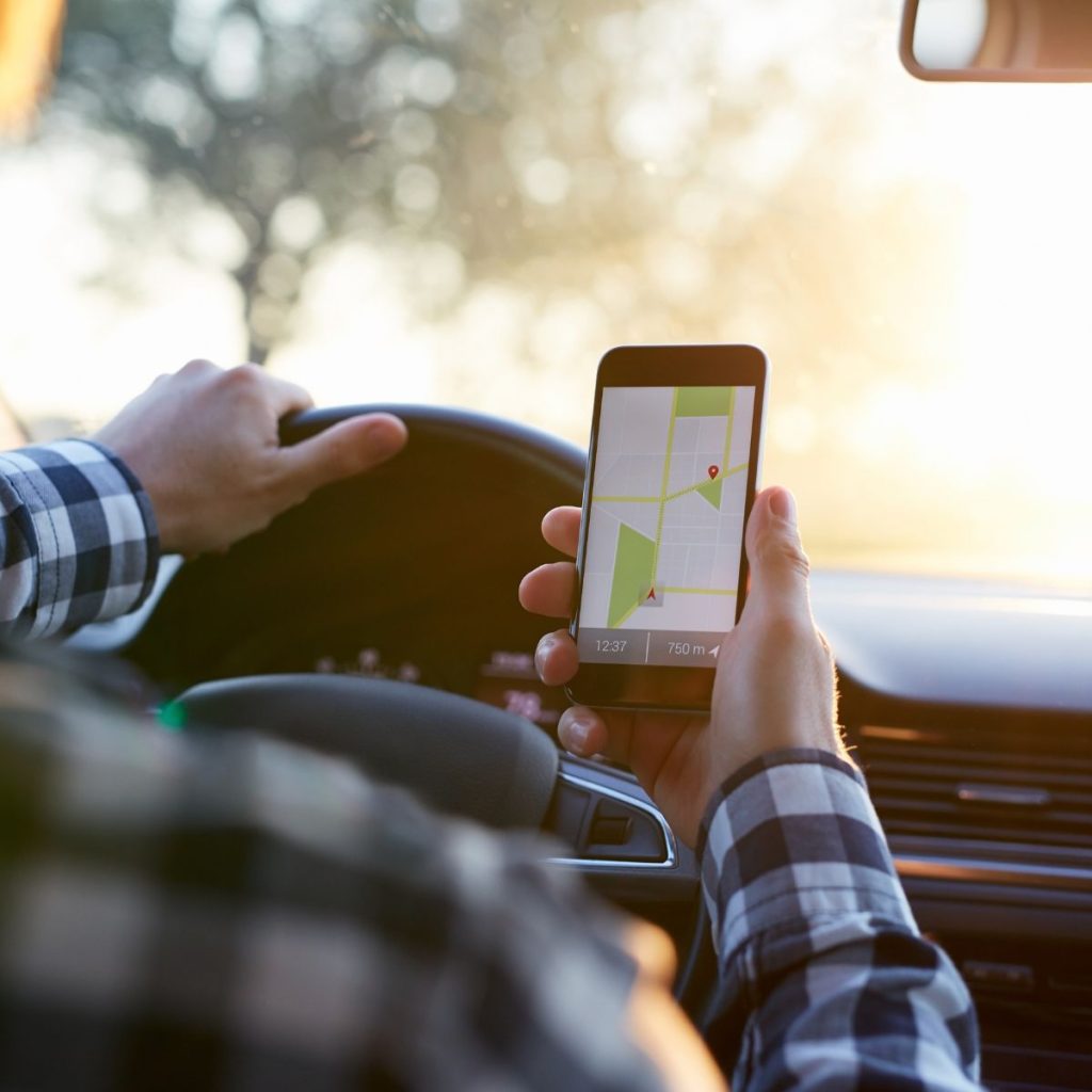 man using a navigator app inside the car