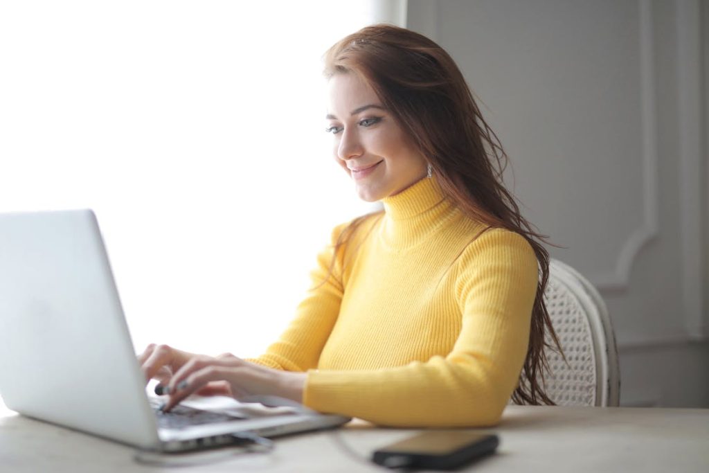 smiling lady using a laptop