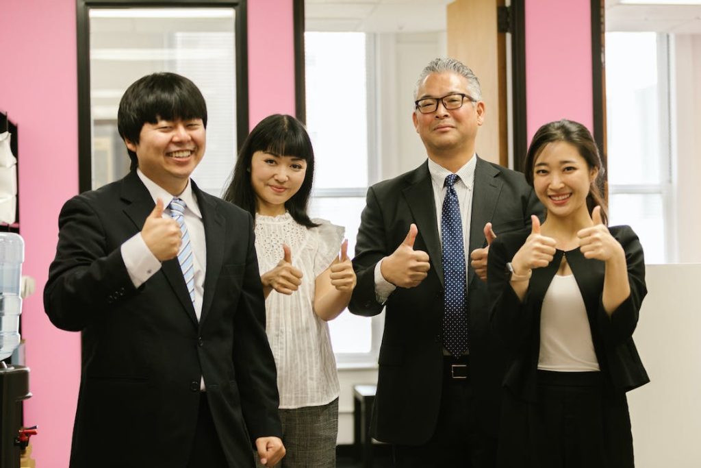 Best Way to Learn to Speak Japanese featuring employees giving a thumbs up