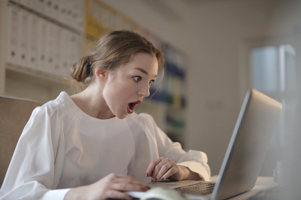 surprised girl looking at the laptop