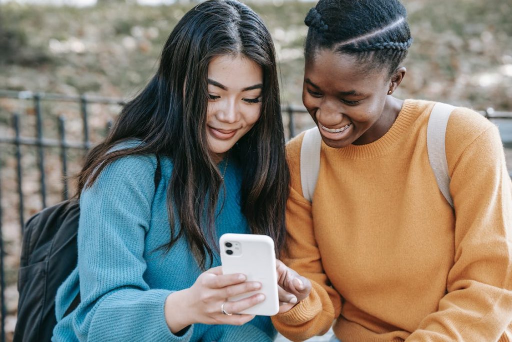 two friends looking at the phone