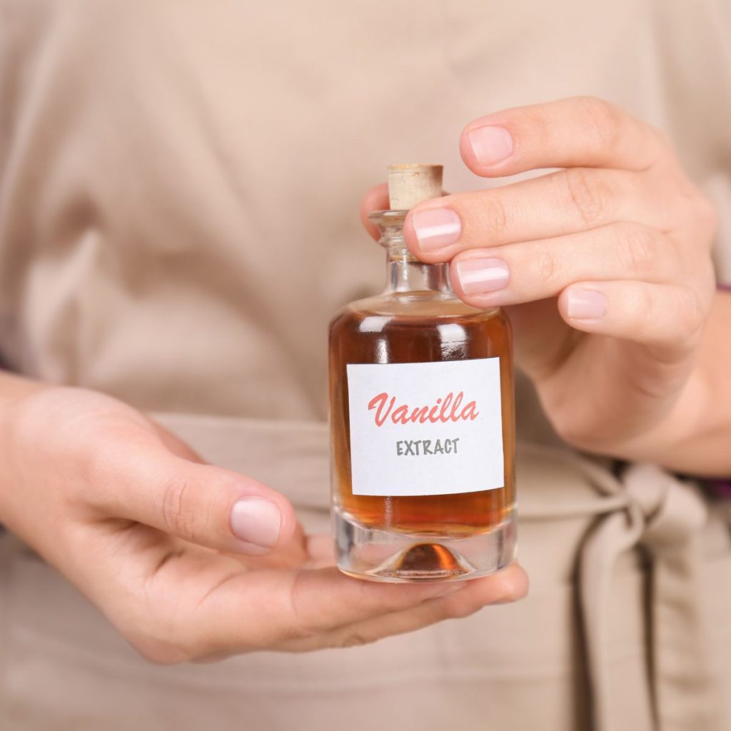 woman holding vanilla extract