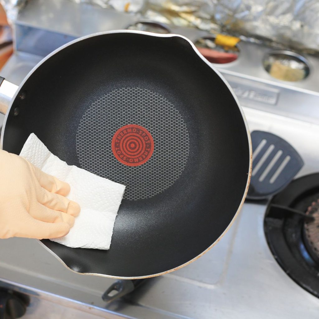 cleaning frying pan with tissue