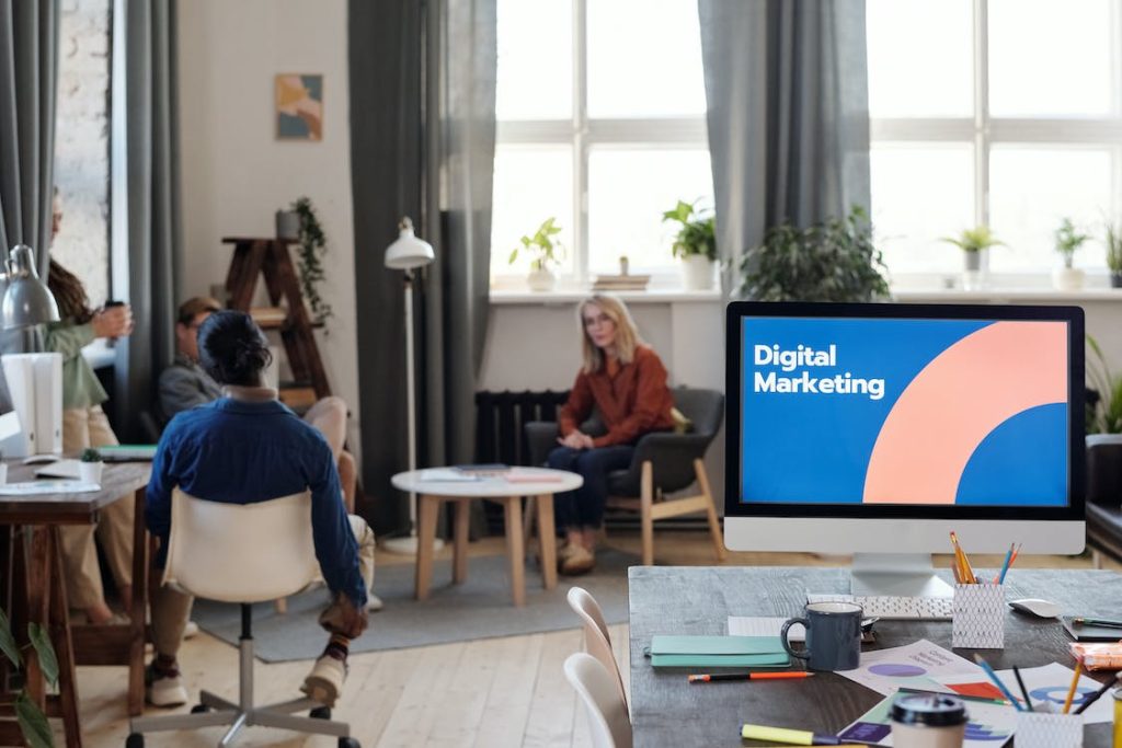 office scene with monitor screen showing digital marketing display