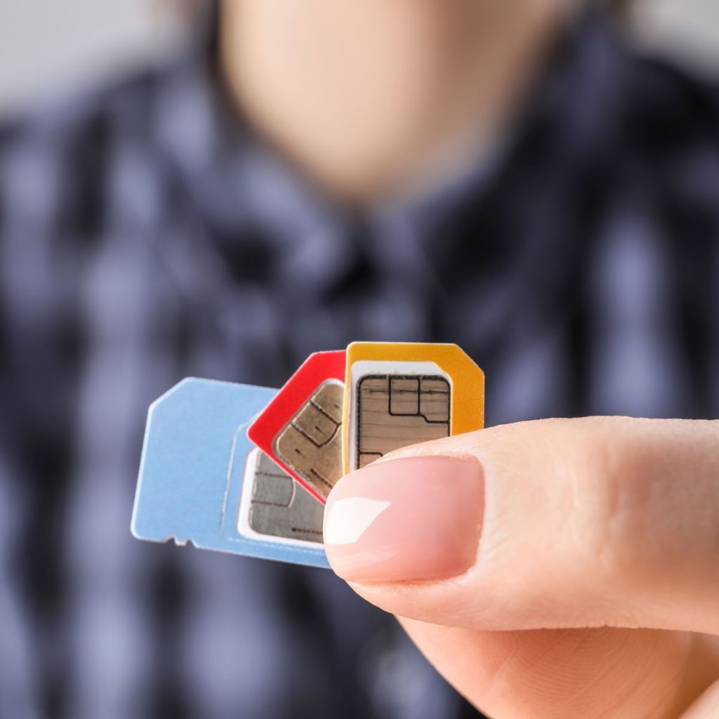 Person holding three different sim cards