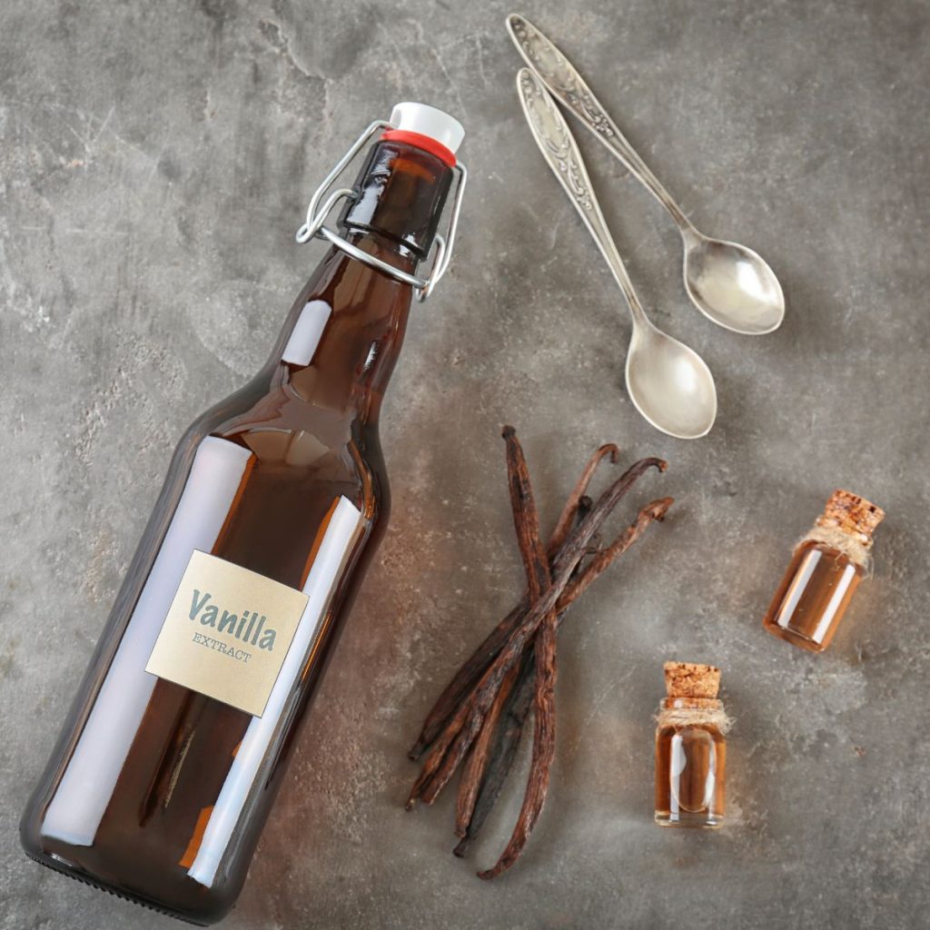 Vanilla Extract in a Bottle with Spoons and Beans