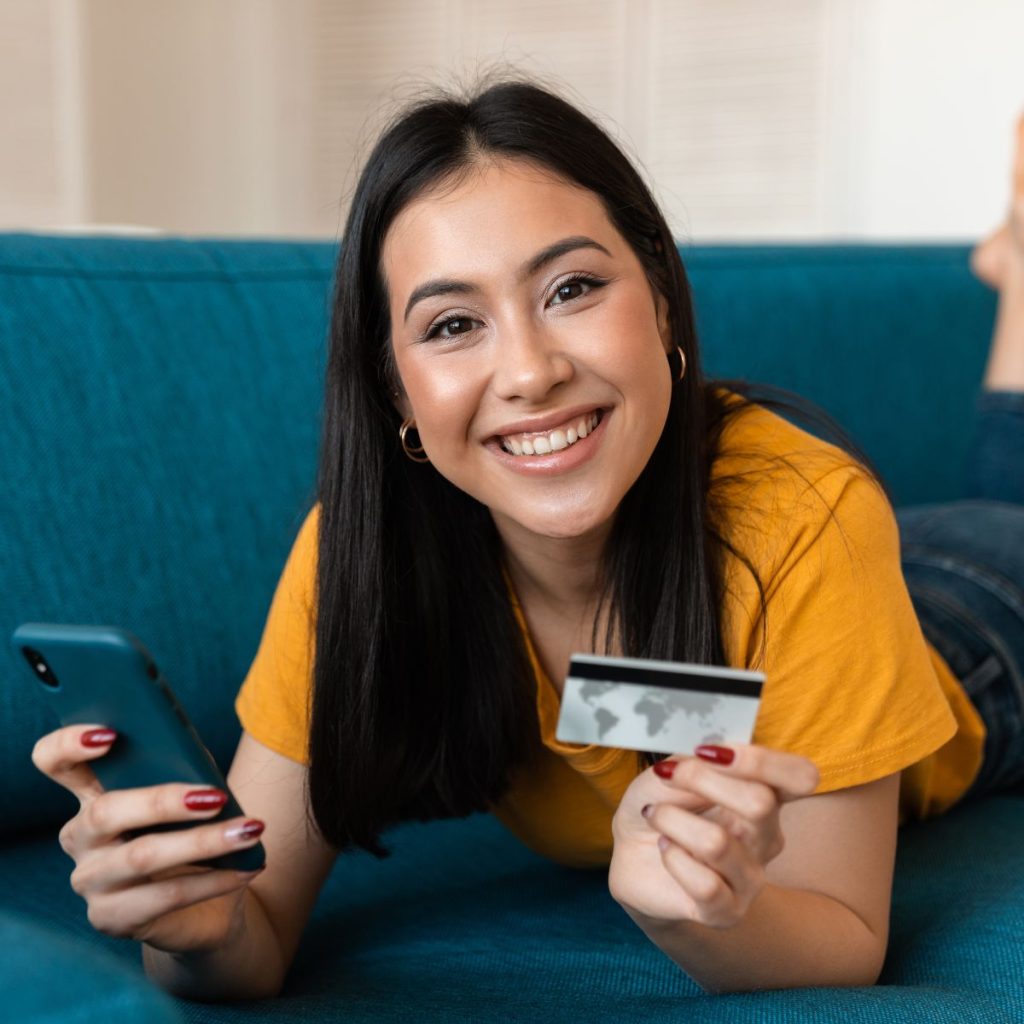 Woman holding smartphone and credit card