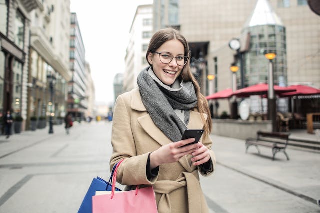 Woman smiling using a smartphone