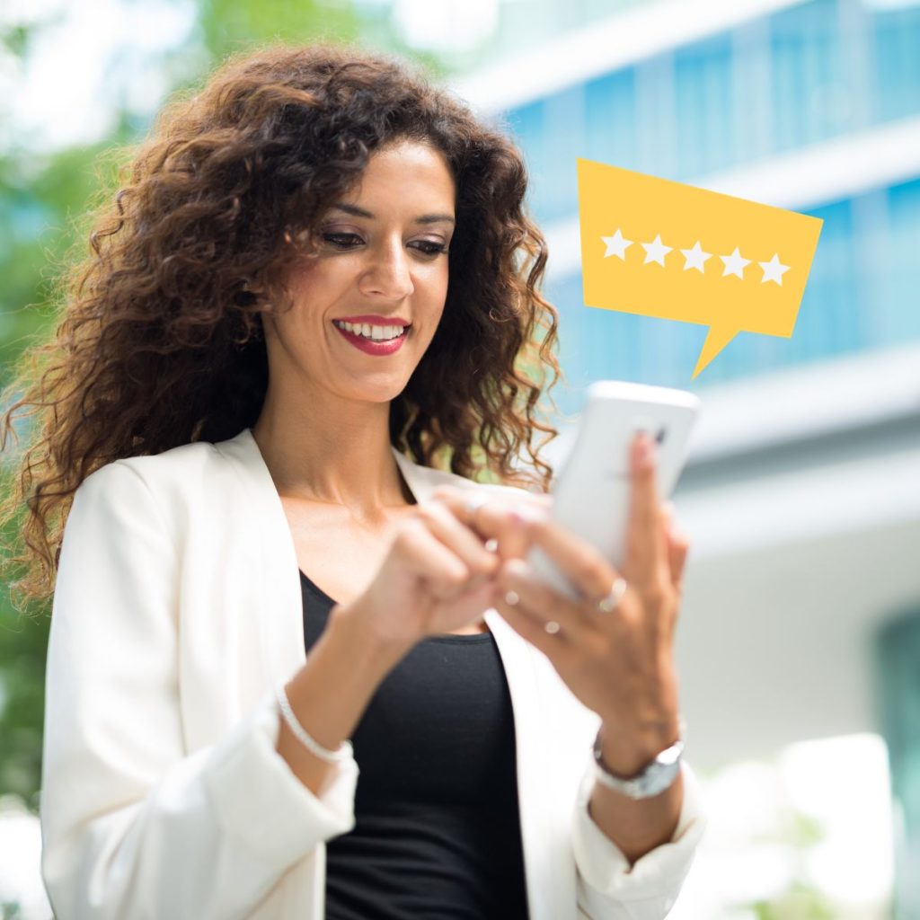 Woman using a smartphone with a floating 5 star rating icon