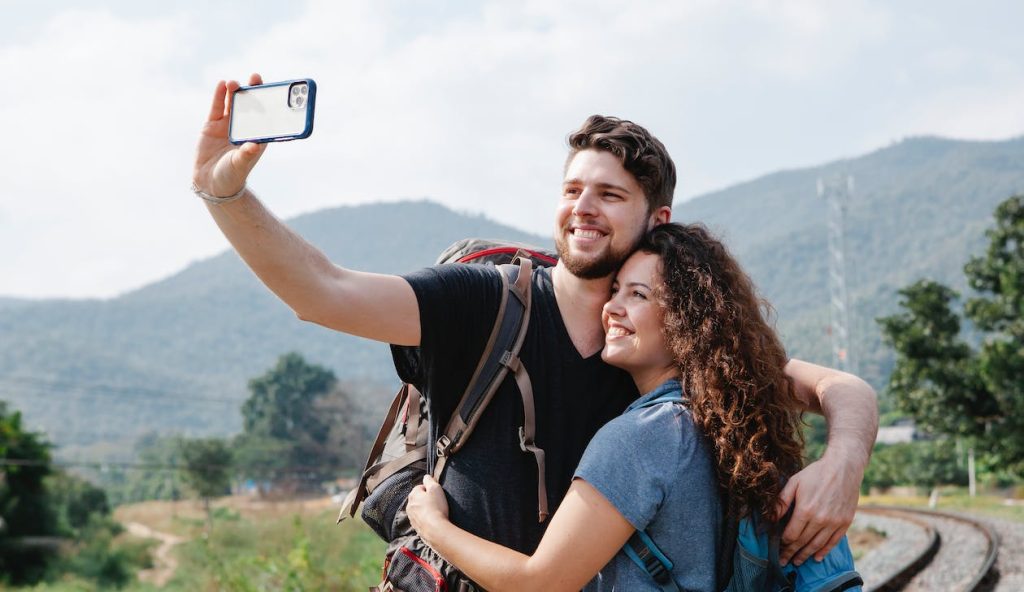 Trip.Com Vs Kiwi.Com featuring a couple taking a selfie