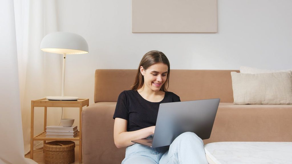 a smiling lady using a laptop