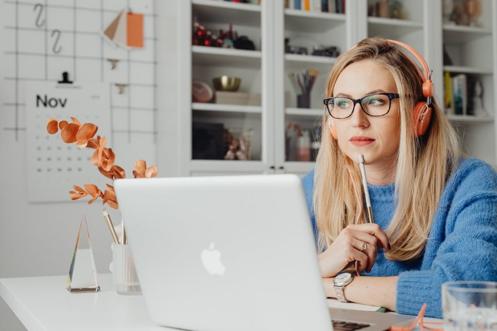 a woman thinking in front of a laptop