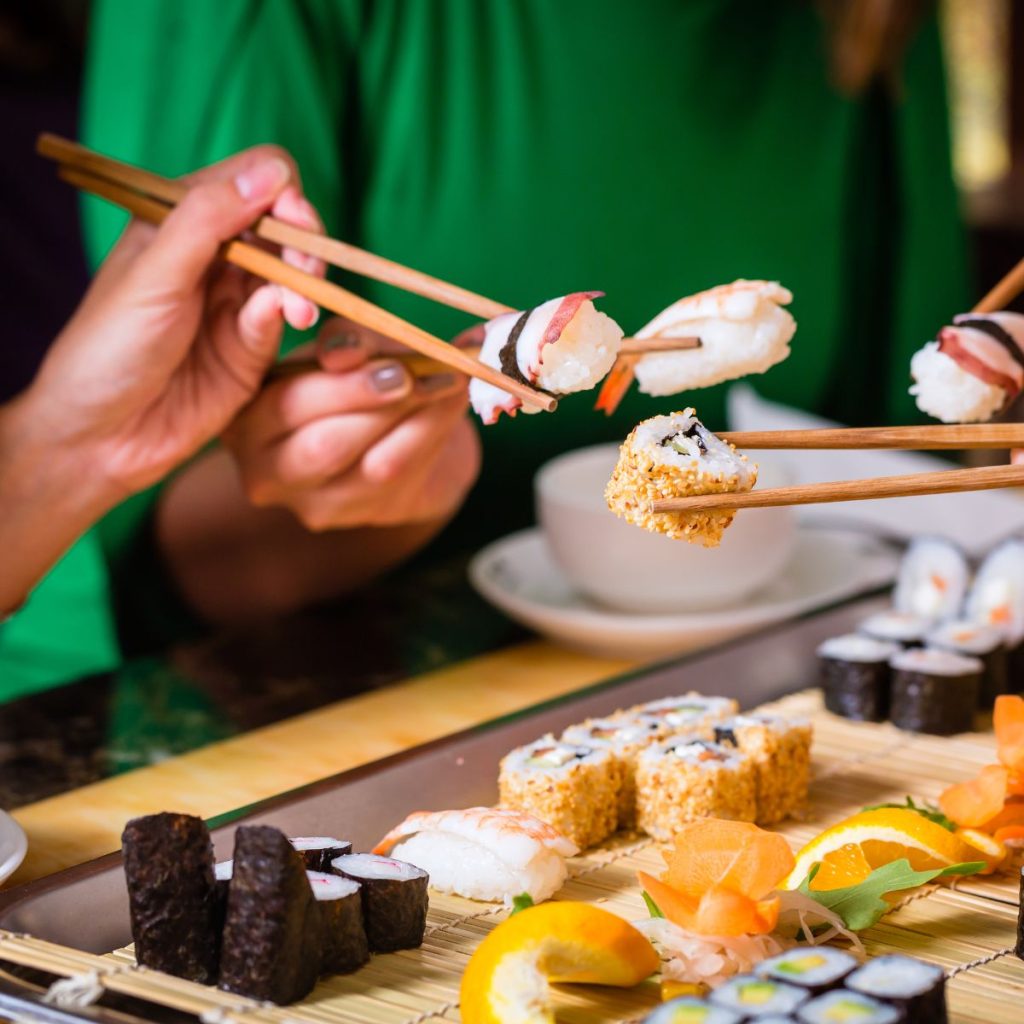 friends holding a sushi